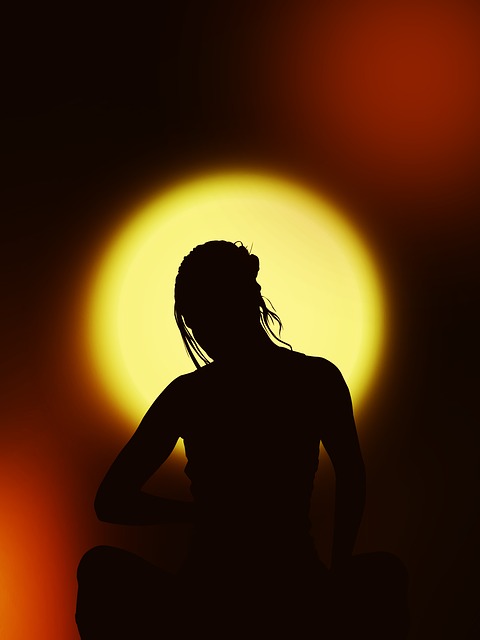 silhouette of a girl meditating in the sunset.